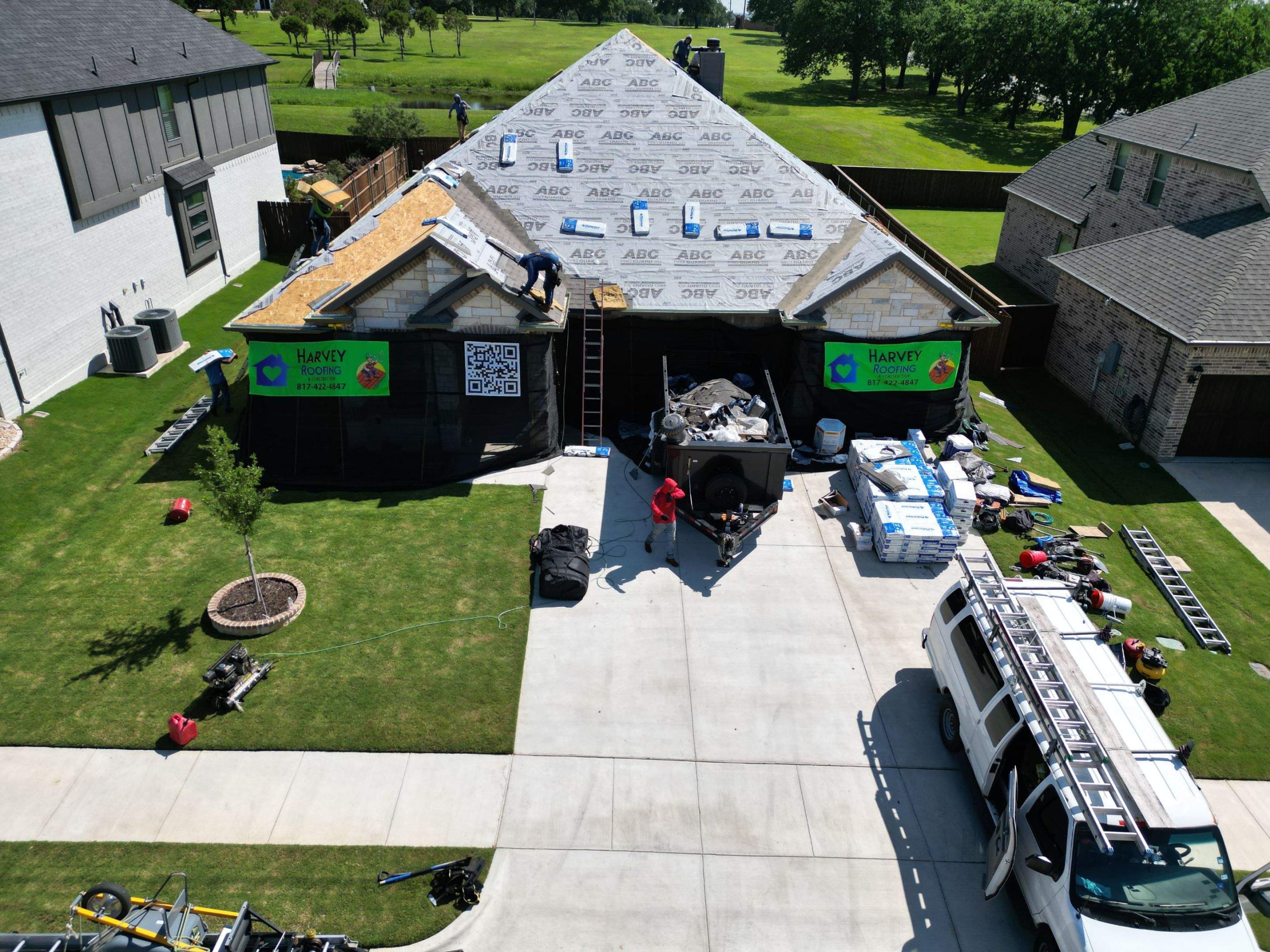 Roofers working on a homes roof replacement